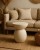stolik kawowy Arene, stolik beżowy MDF, stolik nowoczesny, stolik designerski, stolik minimalistyczny, stolik dekoracyjny do salonu, stolik pomocniczy, stolik artystyczny, stolik harmonijny, stolik rzeźbiarski